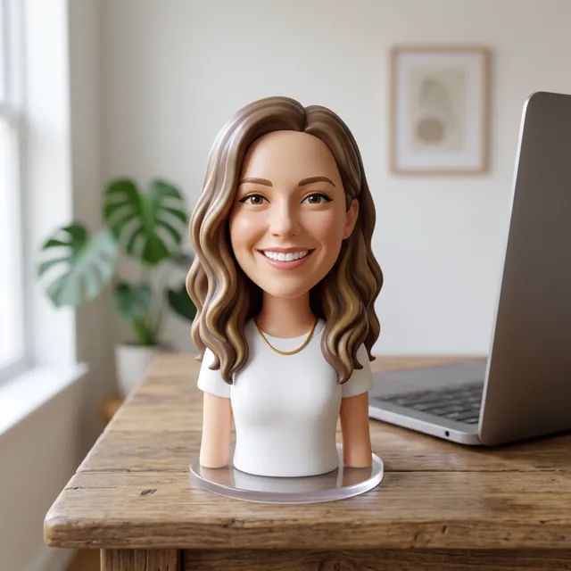 The same woman as a bobblehead figurine on a desk