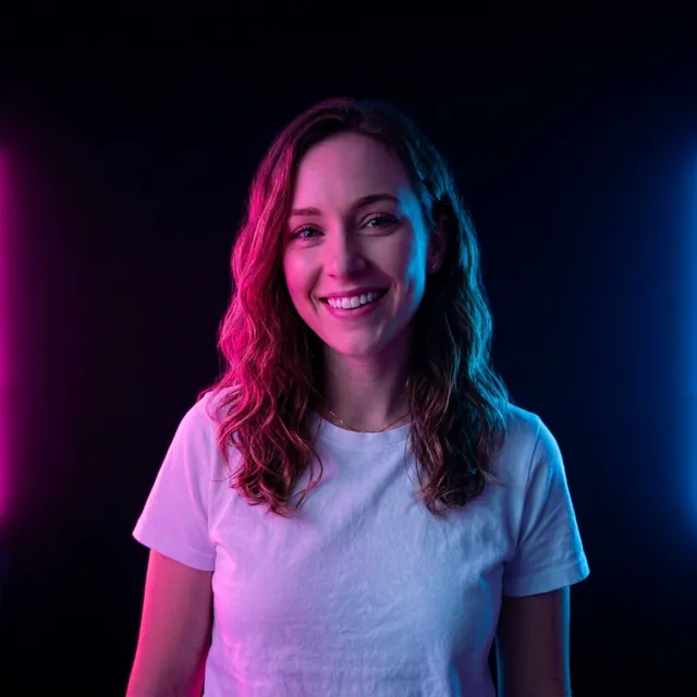 The woman lit by pink and blue neon light